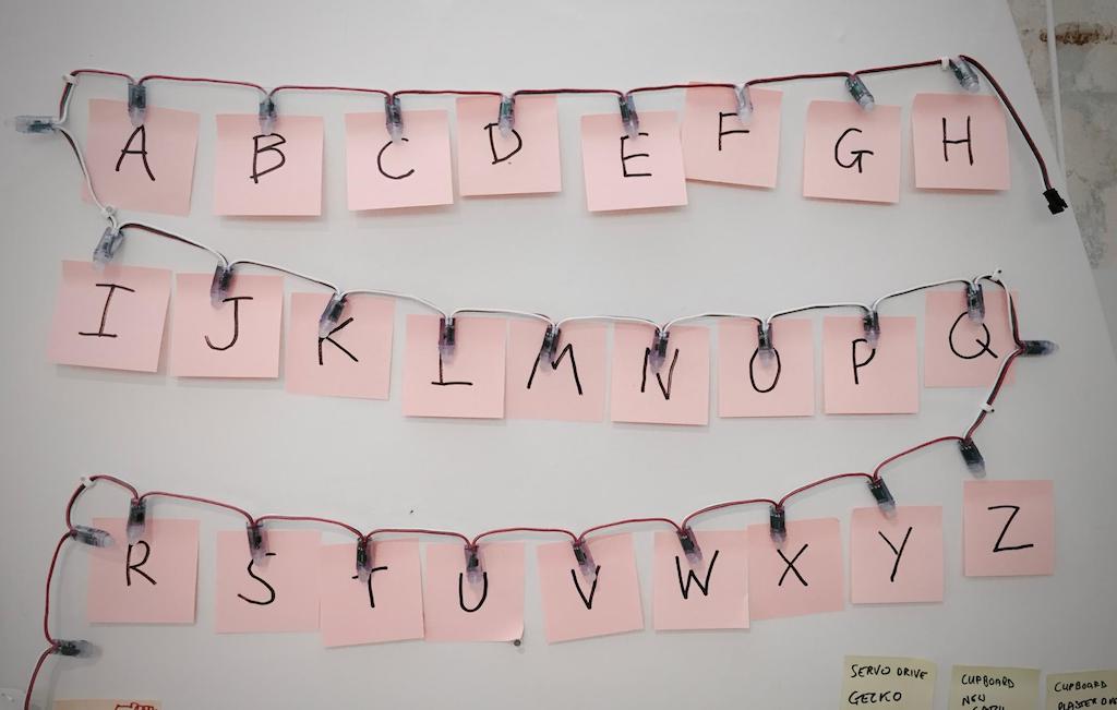 Photo of the lights labelled with a Post-it note for each letter of the alphabet.
